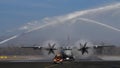 Water Salute to a Propeller Cargo Airplane Taxiing on Military Airport Runway