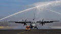 Water Salute to a Propeller Cargo Airplane Taxiing on Military Airport Runway