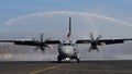 Water Salute to a Propeller Cargo Airplane Taxiing on Military Airport Runway