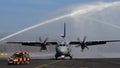 Water Salute to a Propeller Cargo Airplane Taxiing on Military Airport Runway