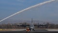 Water Salute to a Propeller Cargo Airplane Taxiing on Military Airport Runway