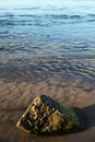 Water near the beach with a single rock