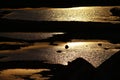 Water shimmering in the sun on a sand pit at sunset