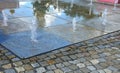 Water showers with stainless steel quarter jets. water features come directly from the cobbled square. circular groove around the