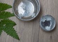 Water in silver bowl with white flower.