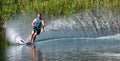 Water Skier with spray and reflection.