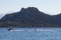 Water skiing on lake behind a boat in Greece Royalty Free Stock Photo