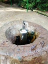 Water in small fountain flowing up high from pipe and form interesting different shape, it is captured in high shutter speed