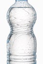 Water. Small plastic water bottle with water drops on white back Royalty Free Stock Photo