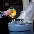 Homeowner adds salt to a water softener Royalty Free Stock Photo