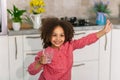 Water is the source of life. Little Black Girl is Holding a Glass of Drinking Water