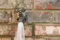 Home water faucet outdoors - spigot - water flowing Royalty Free Stock Photo
