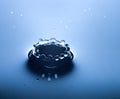 Water splash close up with drops, blue background Royalty Free Stock Photo