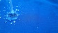 Rain drop on blue surface ,Water splash like a crown ,Water splash in crown shape and falling drop Royalty Free Stock Photo