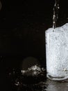 Water splash and crystal glass on black background Royalty Free Stock Photo