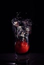 Water splash in a glass isolated on a black background. Royalty Free Stock Photo