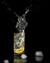Water splash, lemon in the glass with water and ice cubes Isolated on Black Background Royalty Free Stock Photo