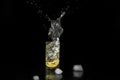 Water splash, lemon in the glass with water and ice cubes Isolated on Black Background Royalty Free Stock Photo