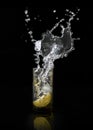 Water splash, lemon in the glass with water and ice cubes Isolated on Black Background Royalty Free Stock Photo