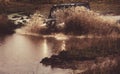 Water splash in off-road racing. SUV race on dirt. Wheel close up in a countryside landscape with a muddy road.