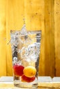 Water splash over glass. Apricot drink