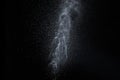 Water splash, spray jet, drops isolated on black background. A splash of water is like lightning, a thunderstorm
