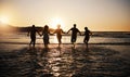 Water splash, sunset and friends holding hands at a beach with freedom, running or fun vacation rear view. Ocean