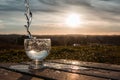 Water splash in the sunset frozen in motion. Teal and orange look against the sunlight with lensflares. Royalty Free Stock Photo