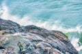 Water splashes close up. Crystal clear sea water beats against the rocks. Sea waves break on the stone shore of the ocean, blue Royalty Free Stock Photo