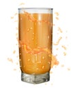 Water splashes in orange colors around a opaque glass