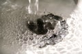 Water splashing down in the sink, close up Royalty Free Stock Photo