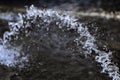 Water splashing from the fountain, jet, aqua drops, clear liquid splash on dark background Royalty Free Stock Photo