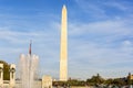 Water splashing from the fountain at the World War II memorial with the Washington Monument in the National Mall in Washington D.C Royalty Free Stock Photo