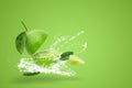 Water splashing on Fresh green lime isolated on green background Royalty Free Stock Photo