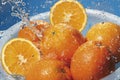 Water splashing on fresh oranges in strainer