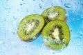 Water splashing on kiwi slices Royalty Free Stock Photo