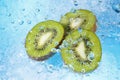 Water splashing on kiwi slices-top view Royalty Free Stock Photo