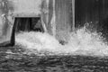 Water splashing and pouring out from a dam overflow concrete culvert Royalty Free Stock Photo