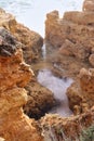 Water splashing in a small pool surrounded by rocks in Portugal Royalty Free Stock Photo