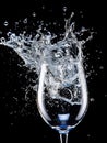 Water splashing into a stemmed waterglass Royalty Free Stock Photo