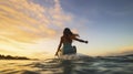 Water sport exercise surfing on summer vacation. A woman surfer paddling surfboard and riding the wave in the sea at tropical Royalty Free Stock Photo