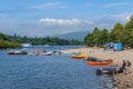 Water sports, boats and kayaks on the shore of Loch Lomond at Balloch in summer, Scotland Royalty Free Stock Photo