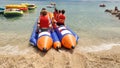 water sports in the sea banana boat fun of a group of young tourists