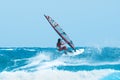 Water sports: windsurfer riding the waves Royalty Free Stock Photo