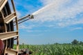 Water sprinkler installation in a field of corn. Royalty Free Stock Photo