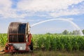 Water sprinkler installation in a field of corn. Royalty Free Stock Photo