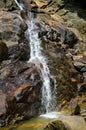 Water stream cascade through rocks close up shot, Elpitiya waterfall, Sri Lanka
