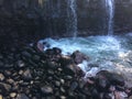 Water Stream Entering Pacific Ocean near Queen`s Bath in Princeville on Kauai Island, Hawaii.