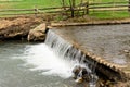 Water in a stream running over a weir Royalty Free Stock Photo