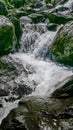 Water stream among stones, mountain spring.